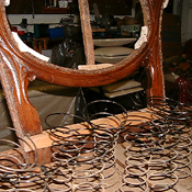 Frame reconstruction in progress — visible joinery and webbing