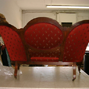 Tufted red-velvet Victorian sofa in the workroom showing tailored upholstery