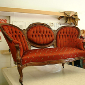Finished Victorian triple-back sofa in deep cordovan damask after restoration